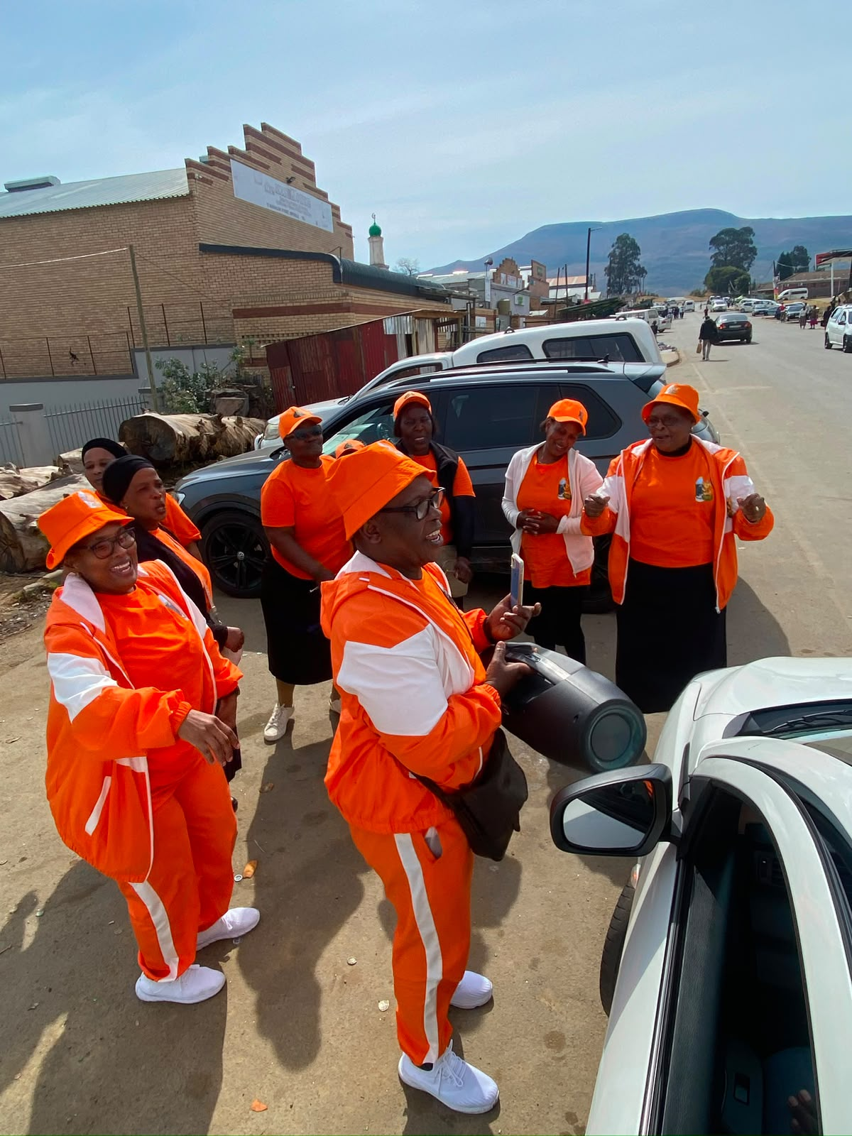 Amabhubesi Amhlophe distributors in orange tracksuits promoting the range