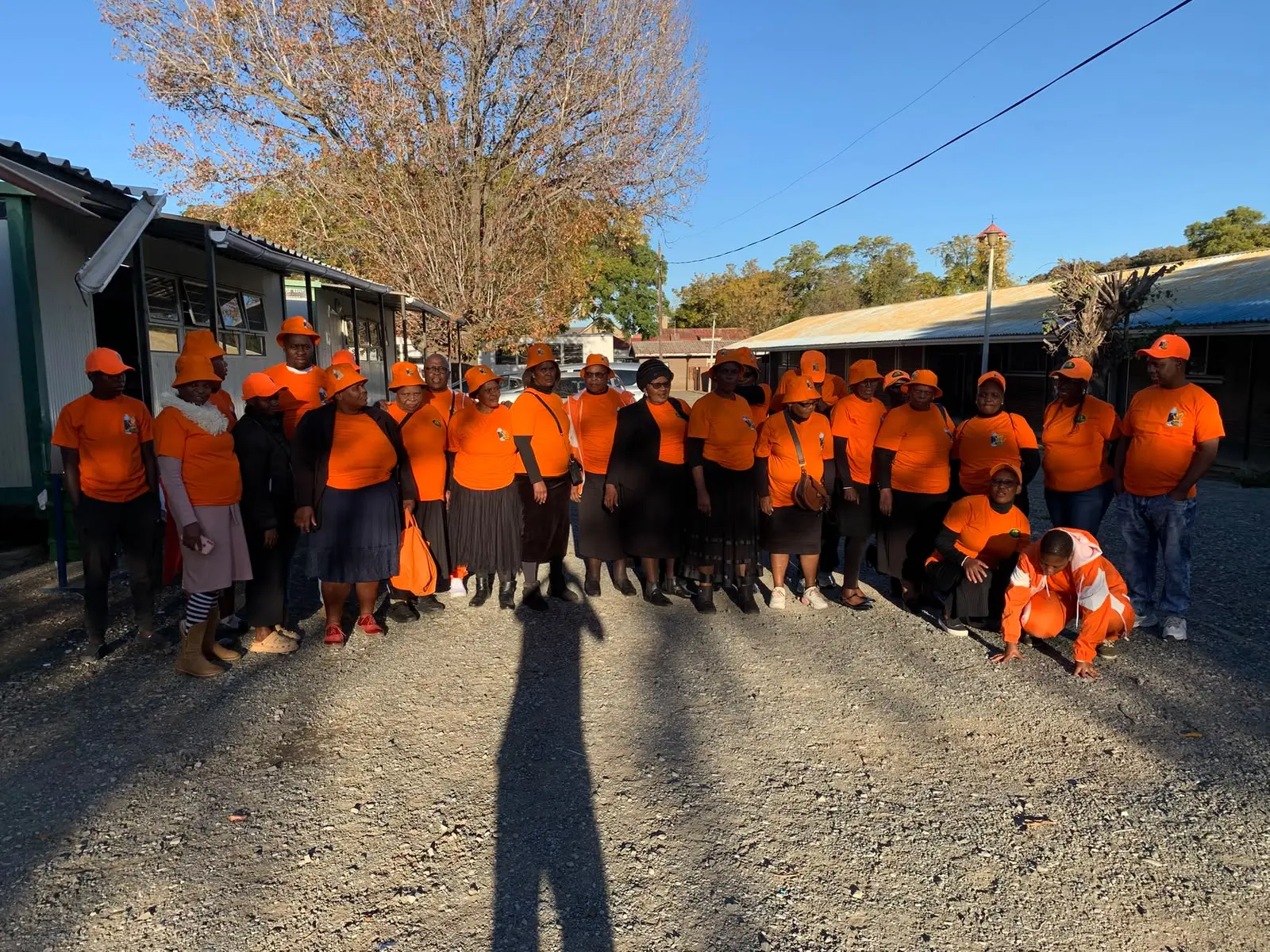 A large group of Amabhubesi Amhlophe distributors in branded orange shirts